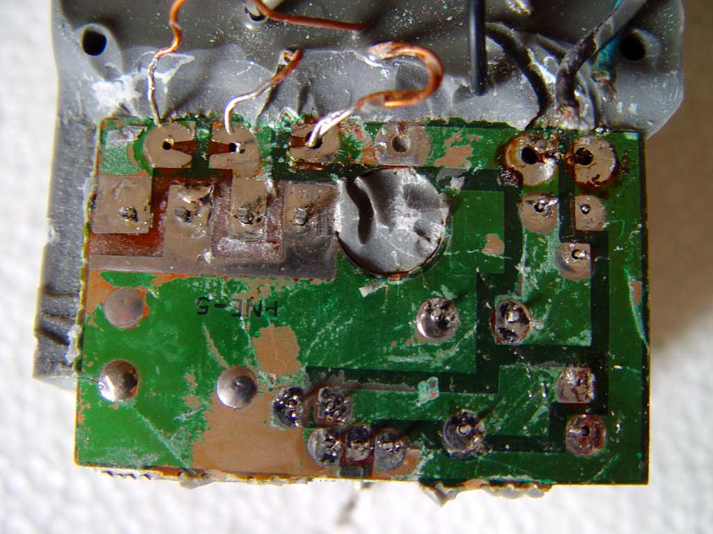 The now desoldered board is now almost
 ready to be carefully freed from the resin